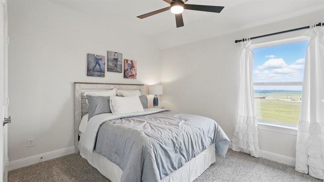 Bedroom featuring a large window, neutral wall paint, and plush carpet flooring