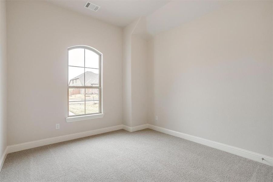 Unfurnished room featuring carpet