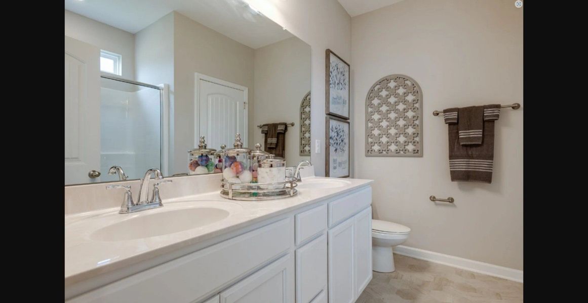 Stock photo of owner's bath with large shower and linen closet