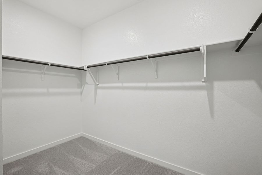 A white wall with a metal railing.