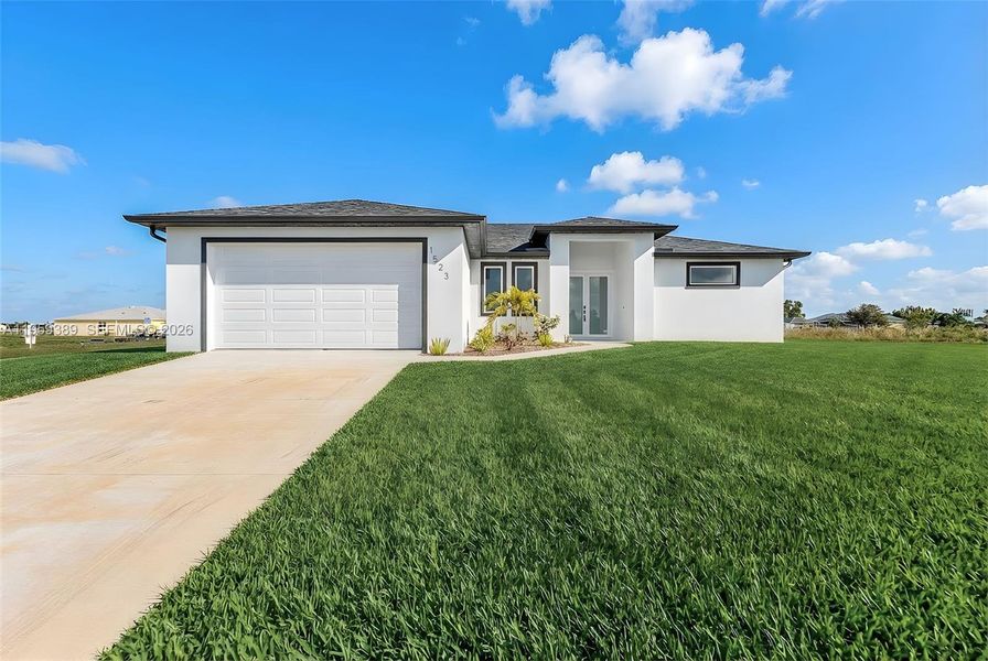 Front exterior of a new home in , Cape Coral, FL, highlighting curb appeal (Image 1). Front exterior of a new home in , Cape Coral, FL, highlighting curb appeal (Image 1).