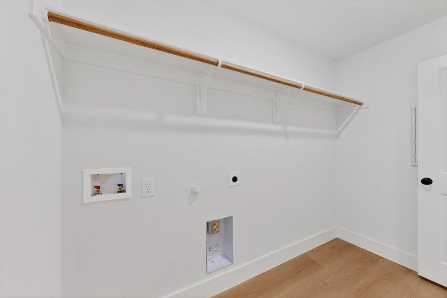 Laundry room featuring light wood-style flooring, hookup for a washing machine, gas dryer hookup, and electric dryer hookup