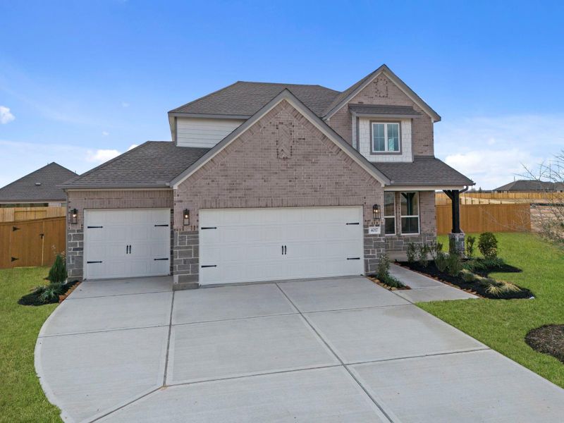Front exterior of a new home in Sunterra Lakes, Fulshear, TX, highlighting curb appeal (Image 19). Front exterior of a new home in Sunterra Lakes, Fulshear, TX, highlighting curb appeal (Image 19).