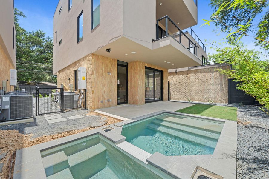 A tranquil backyard oasis features a modern pool and spa, perfect for relaxation and entertainment. A tranquil backyard oasis features a modern pool and spa, perfect for relaxation and entertainment.
