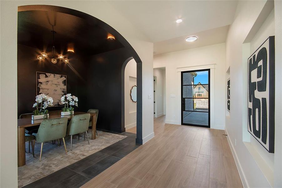 Entryway featuring arched walkways, wood finished floors, recessed lighting, and a chandelier Entryway featuring arched walkways, wood finished floors, recessed lighting, and a chandelier