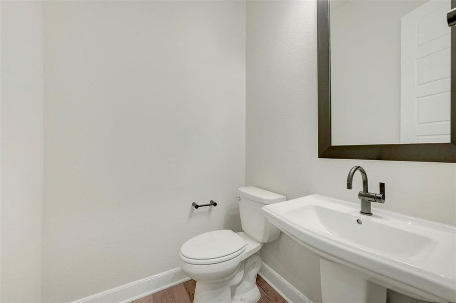 Bathroom with baseboards and wood finished floors