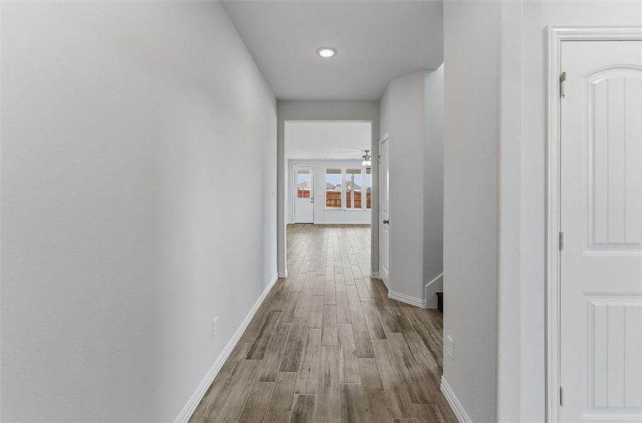 Hall featuring wood finished floors and baseboards