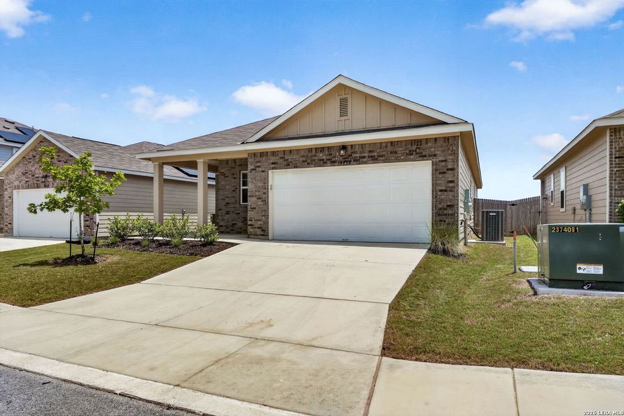 Front exterior of a new home in Hennersby Hollow, San Antonio, TX, highlighting curb appeal (Image 16).