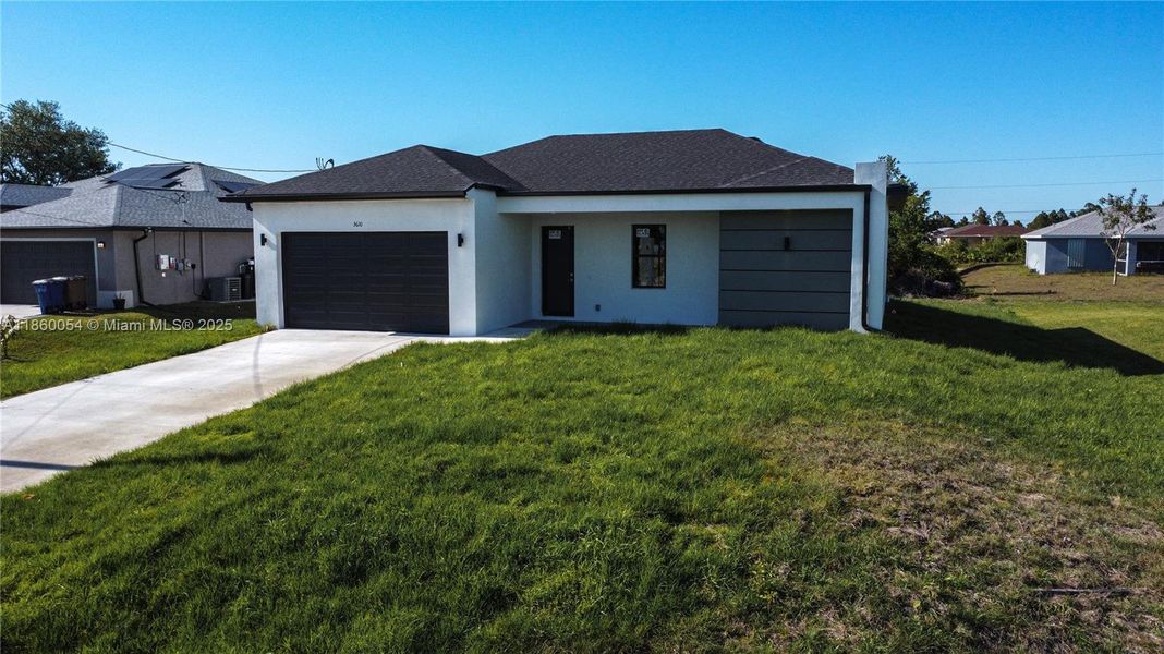 Front exterior of a new home in , Lehigh Acres, FL, highlighting curb appeal (Image 24).