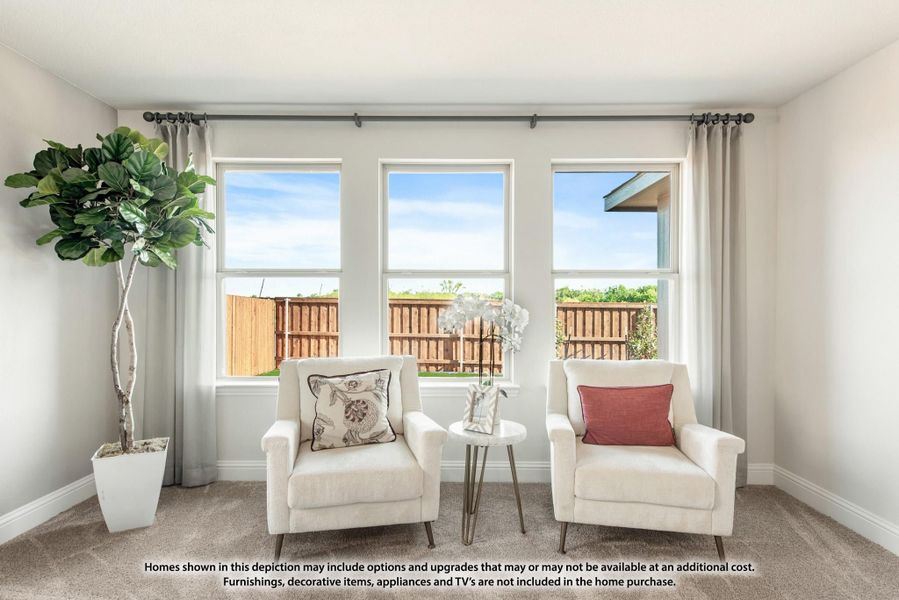 Sitting area with two white armchairs, small side table, and three windows overlooking a fenced backyard Sitting area with two white armchairs, small side table, and three windows overlooking a fenced backyard