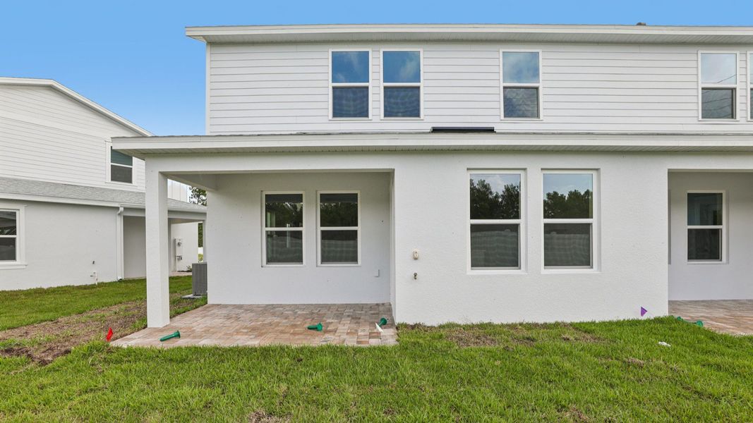 Exterior details and patio area of a home in Cyrene at Harmony, St. Cloud (Image 22).
