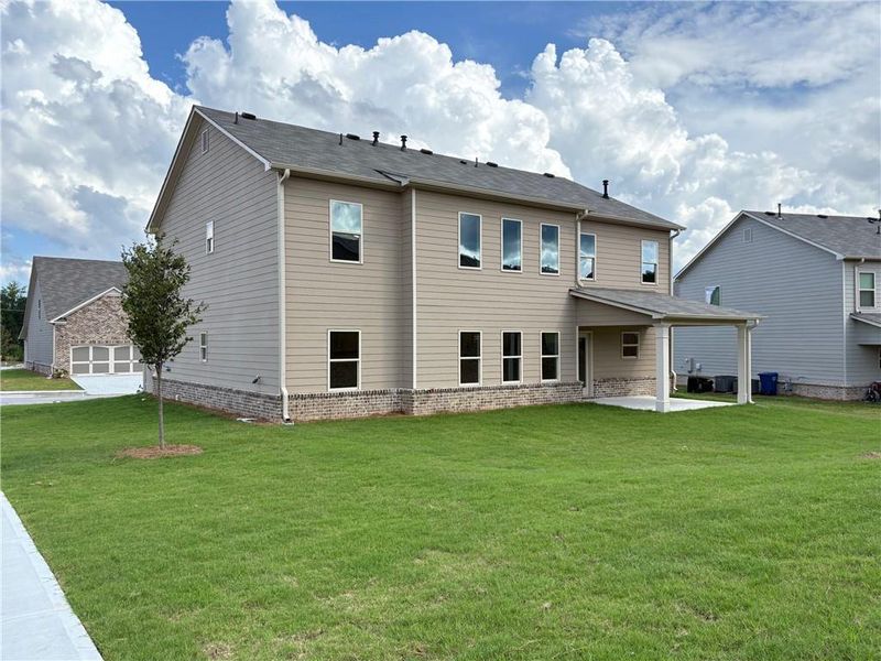 Front exterior of a new home in , Loganville, GA, highlighting curb appeal (Image 18).