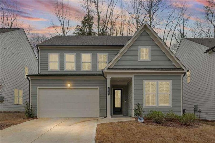 Front exterior of a new home in Enclave at Edgewater, Holly Springs, GA, highlighting curb appeal (Image 2). Front exterior of a new home in Enclave at Edgewater, Holly Springs, GA, highlighting curb appeal (Image 2).