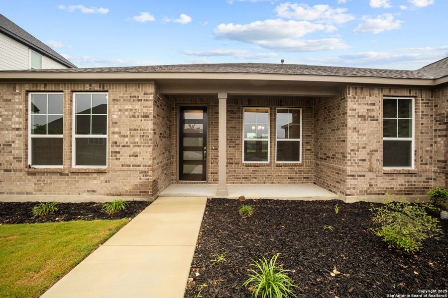 Front exterior of a new home in Potranco Oaks, Castroville, TX, highlighting curb appeal (Image 24).