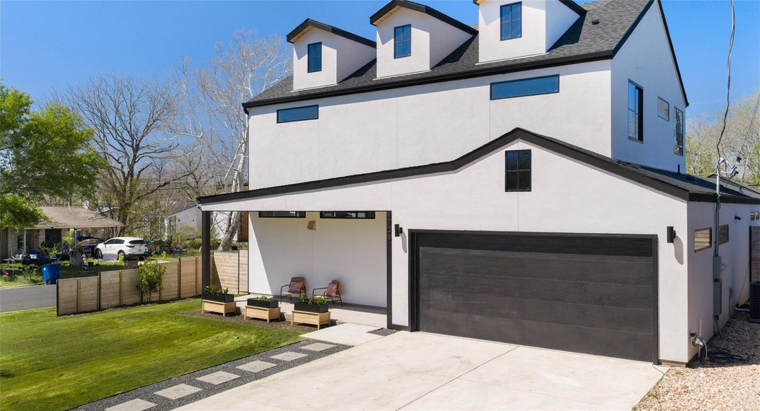 View of front of property with an attached garage, stucco siding, driveway, and a shingled roof