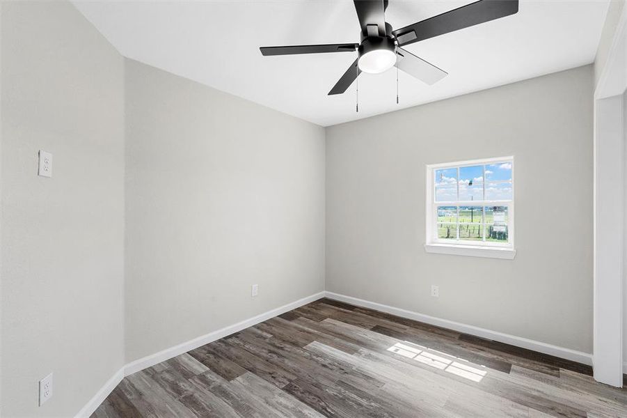 Empty room featuring light wood-style floors and ceiling fan Empty room featuring light wood-style floors and ceiling fan