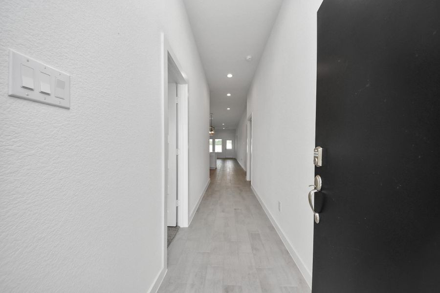 As you step into the threshold of this luxurious home, you'll soon be welcomed by an elegant glass door (to be installed). Inside, soaring ceilings amplify the spaciousness, while the refined wood-look tile flooring and oversized baseboards exude sophistication and charm. Sample photo of completed home with similar floor plan. Actual colors and selections may vary.