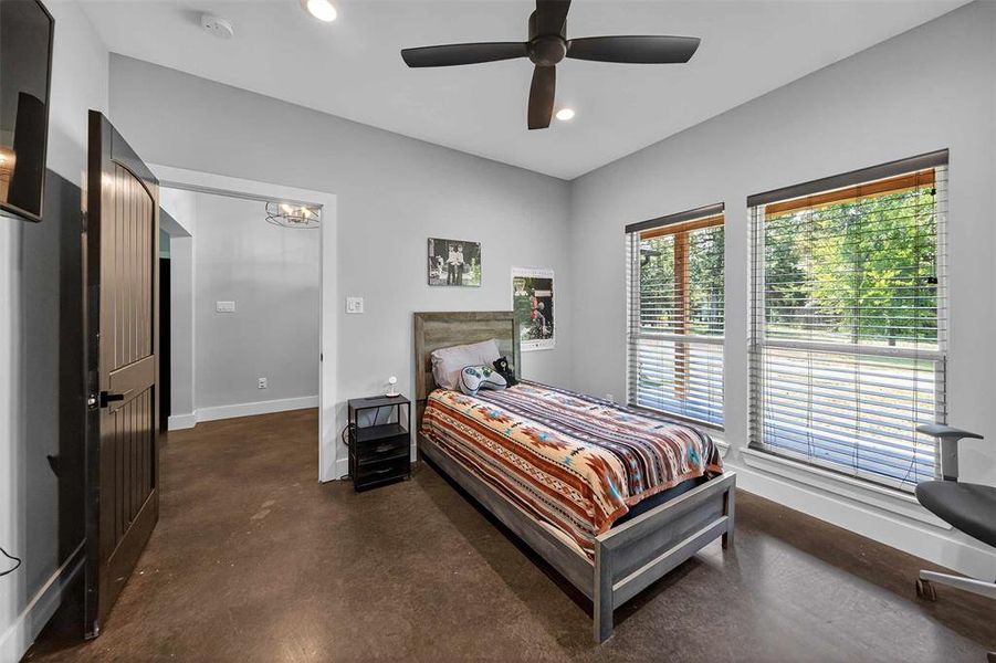 Bedroom featuring finished concrete floors, recessed lighting, and ceiling fan Bedroom featuring finished concrete floors, recessed lighting, and ceiling fan