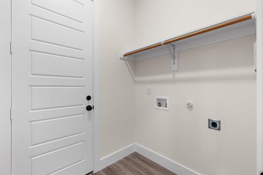 Laundry room featuring electric dryer hookup, hookup for a gas dryer, hookup for a washing machine, and hardwood / wood-style flooring