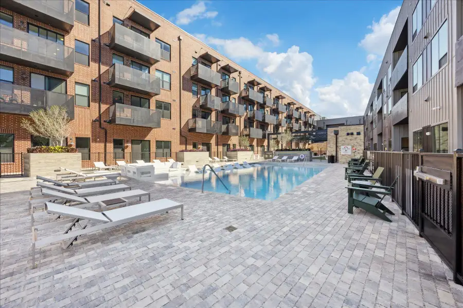 An inviting community pool surrounded by modern brick and metal-clad structures offers relaxation and recreation. An inviting community pool surrounded by modern brick and metal-clad structures offers relaxation and recreation.