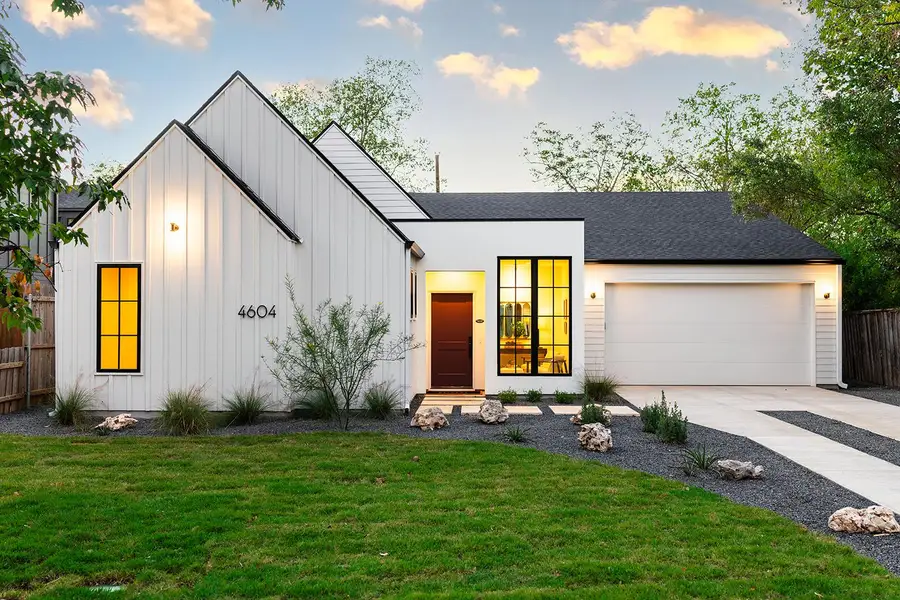 Modern inspired farmhouse with board and batten siding, a shingled roof, driveway, and an attached garage