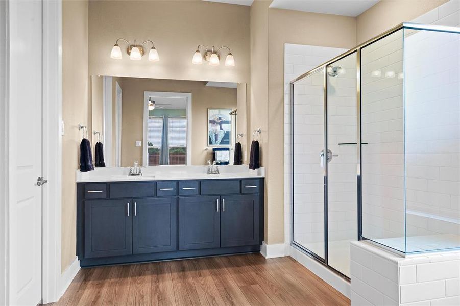 The primary bath features dual sinks and a large shower.