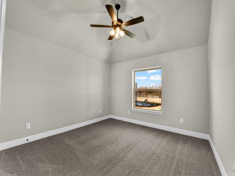 Carpeted empty room with ceiling fan