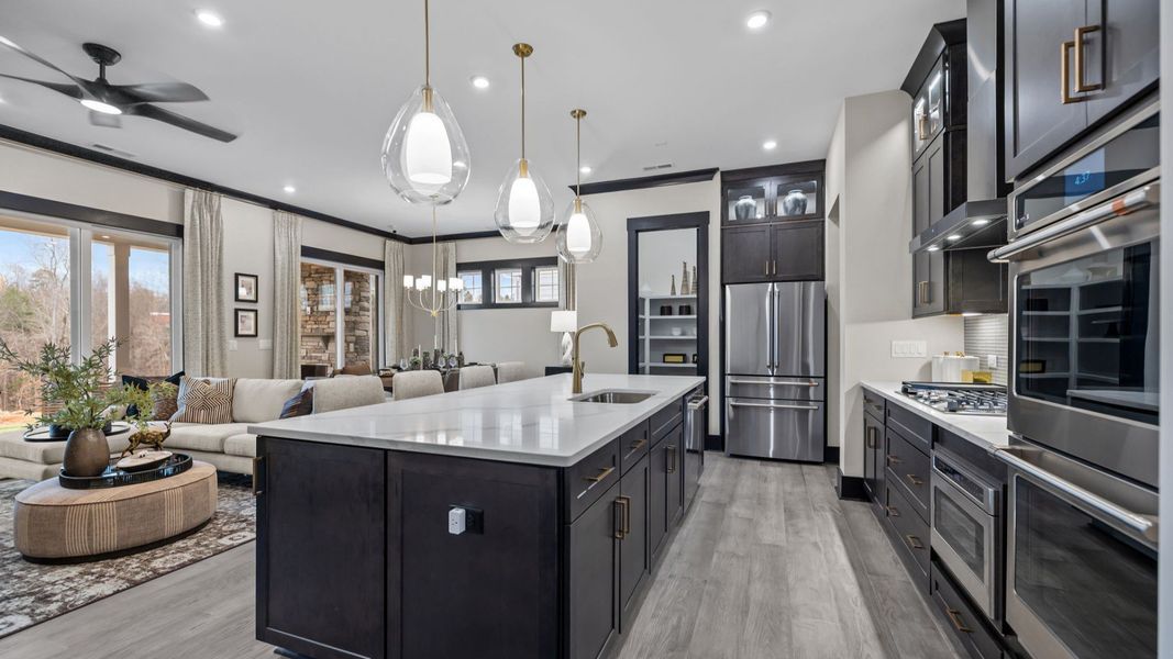 The Enthusiast Plan by DBR Homes kitchen and living area with modern features in Fort Mill, SC.