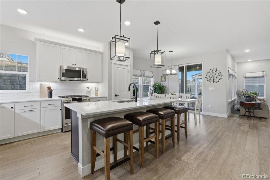 The kitchen has quartz countertops, bar seating and stainless steel appliances.