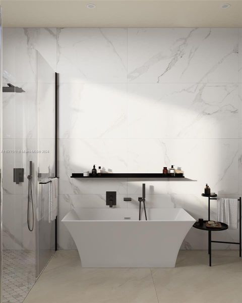 A freestanding Randolph Morris tub is perfectly complemented by Rossalini polished porcelain tiles (30x60), which flow seamlessly throughout the space.