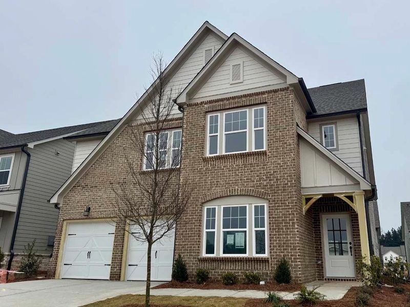 Front exterior of a new home in Eastlyn Crossing - Single Family, Flowery Branch, GA, highlighting curb appeal (Image 2). Front exterior of a new home in Eastlyn Crossing - Single Family, Flowery Branch, GA, highlighting curb appeal (Image 2).