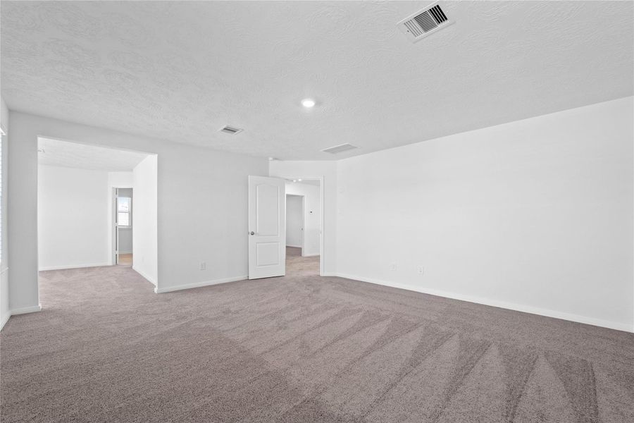 Another view from the primary bedroom looking to the sitting area that leads to the primary bathroom.