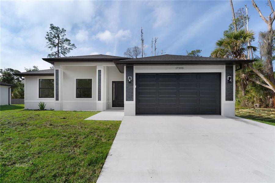 Front exterior of a new home in , Port Charlotte, FL, highlighting curb appeal (Image 16).