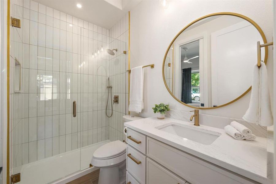 Bathroom with a shower stall, vanity, and a ceiling fan Bathroom with a shower stall, vanity, and a ceiling fan