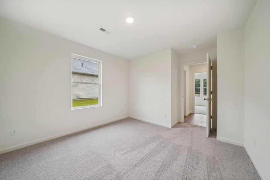 A hallway with white walls.
