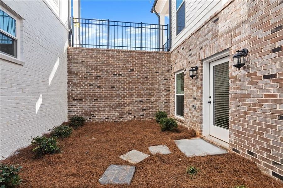 Enjoy your private courtyard and create the space you desire out here! Not actual home. Photo of previously built Grayton floorplan.