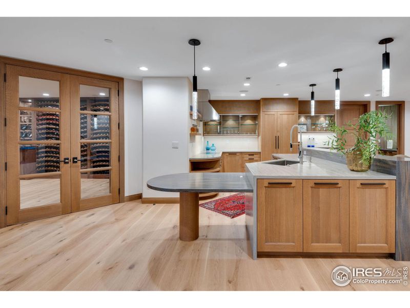 Custom Rift White Oak Island with solid surface countertop and bar top with waterfall edge.