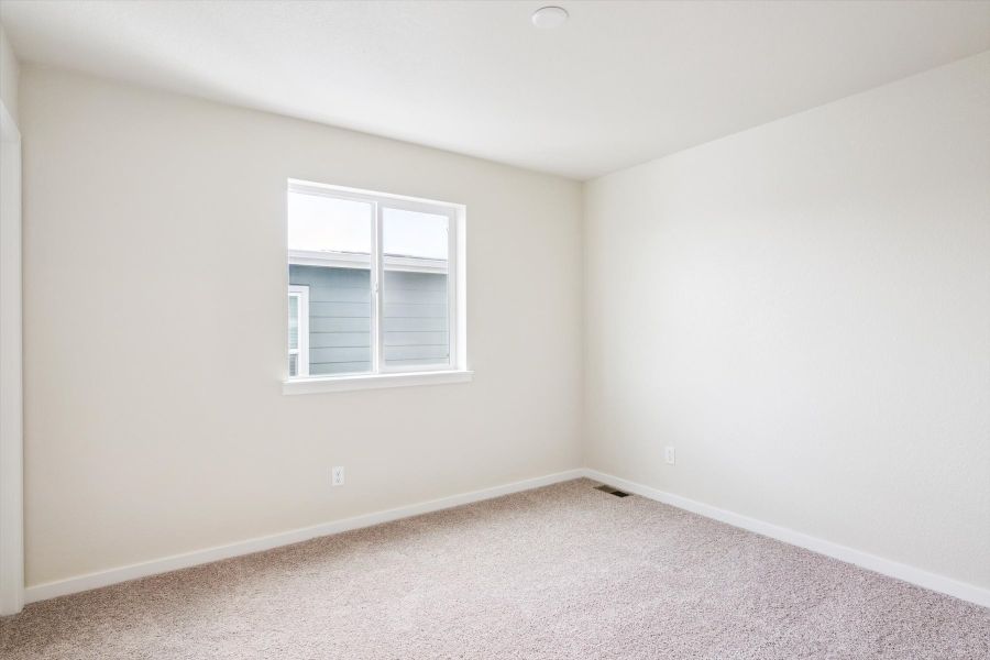A room with a window and carpet.