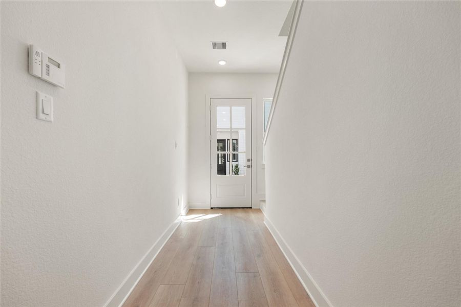 Walking into this gorgeous home, you get a feel of just how open and bright everything is. This space showcases soaring high ceilings, recessed lighting, custom paint for a cooling feel, and gorgeous wood flooring. This home is absolutely beautiful!