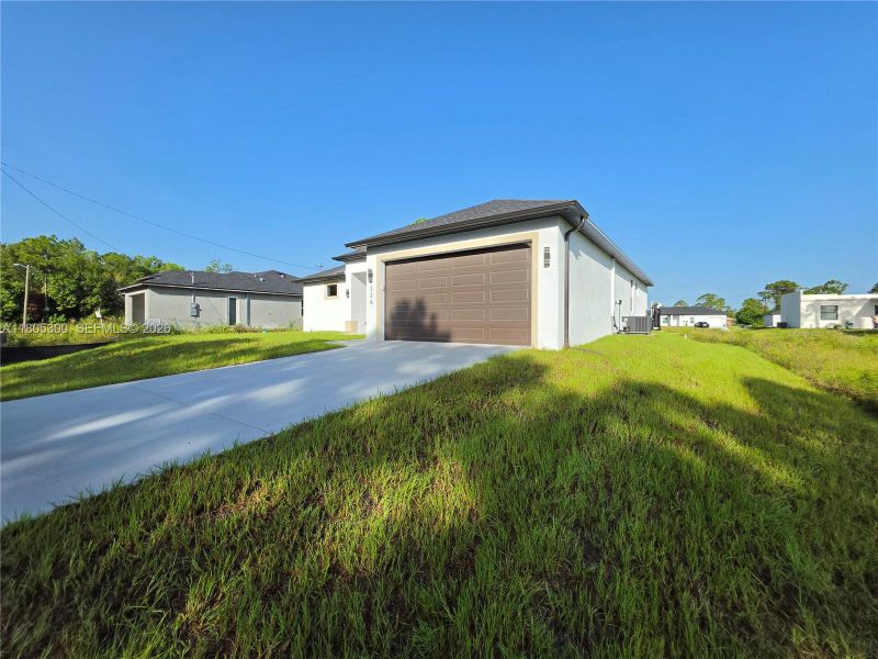 Front exterior of a new home in , Lehigh Acres, FL, highlighting curb appeal (Image 20).
