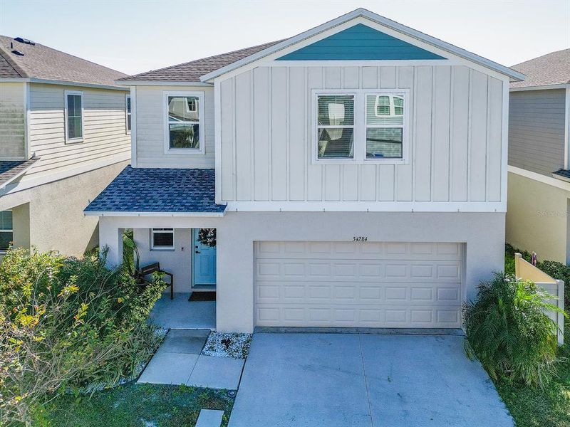 Front exterior of a new home in Pasadena Point, Wesley Chapel, FL, highlighting curb appeal (Image 2). Front exterior of a new home in Pasadena Point, Wesley Chapel, FL, highlighting curb appeal (Image 2).