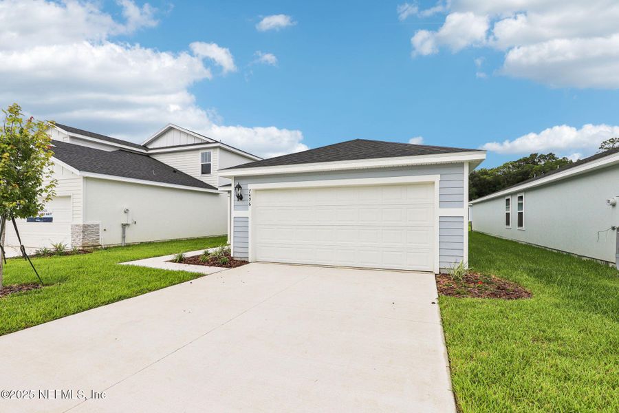 Front exterior of a new home in Kings Crossing, Jacksonville, FL, highlighting curb appeal (Image 18). Front exterior of a new home in Kings Crossing, Jacksonville, FL, highlighting curb appeal (Image 18).