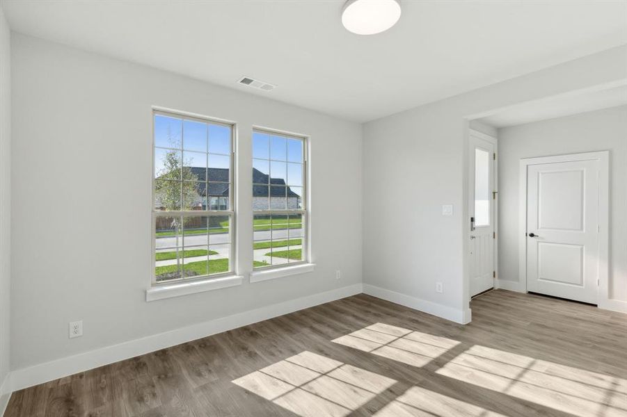 Spare room featuring light wood-type flooring