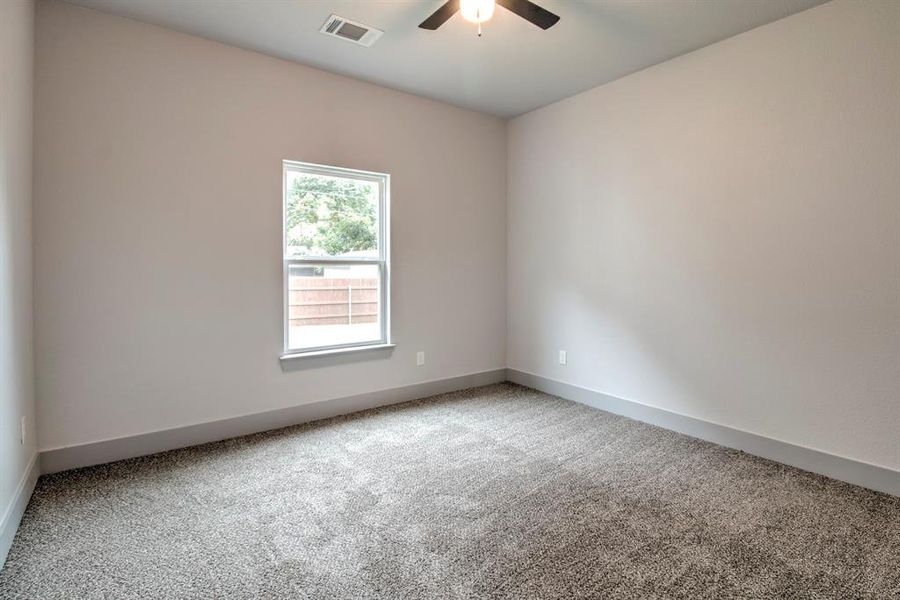 Spare room featuring carpet and ceiling fan Spare room featuring carpet and ceiling fan