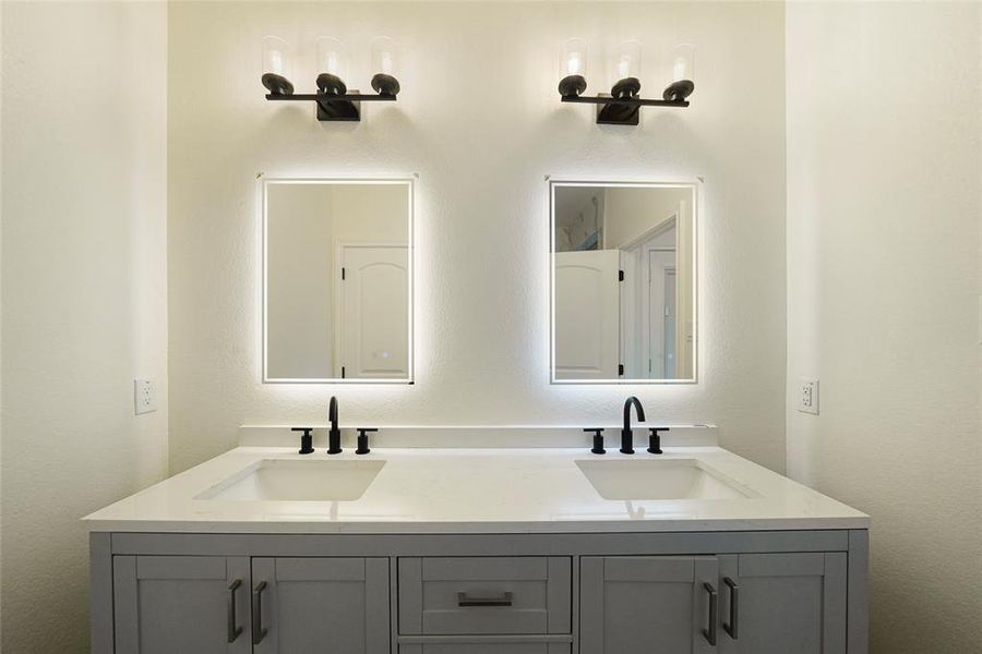 Double vanity with two sinks. The LED mirror is controlled by touch and can be set to different lighting options.