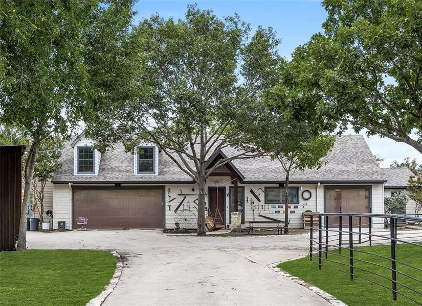 View of front of house featuring a front yard and a garage