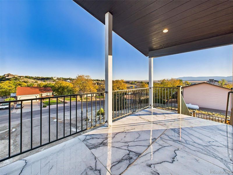 Spacious covered deck featuring stylish tile flooring and stunning panoramic views of Pueblo Reservoir and the Spanish Peaks. Spacious covered deck featuring stylish tile flooring and stunning panoramic views of Pueblo Reservoir and the Spanish Peaks.
