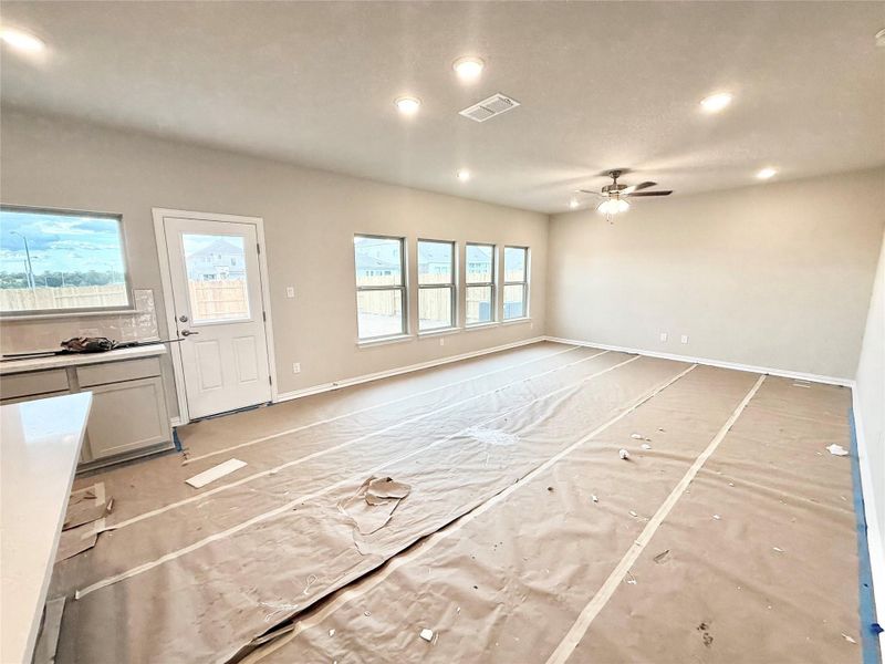 Unfurnished living room featuring a ceiling fan and recessed lighting Unfurnished living room featuring a ceiling fan and recessed lighting