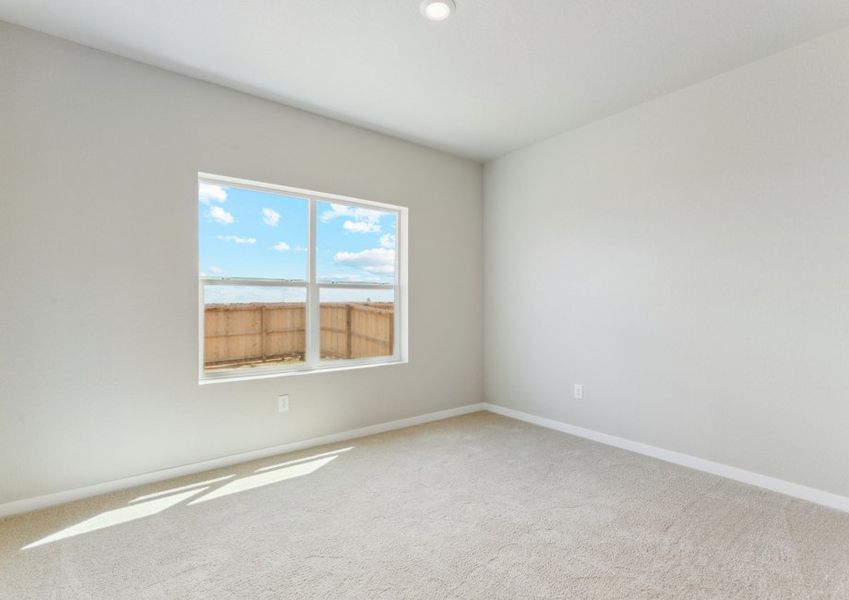 The master bedroom is spacious with a large window.