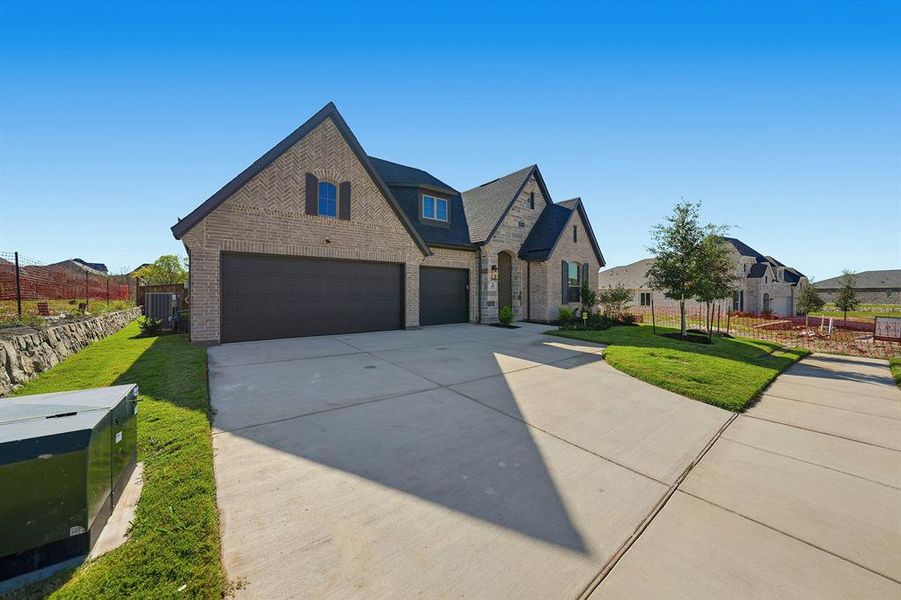 Front exterior of a new home in Devonshire, Forney, TX, highlighting curb appeal (Image 22). Front exterior of a new home in Devonshire, Forney, TX, highlighting curb appeal (Image 22).